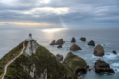 Nugget point lighthouse at sunrise, new zealand