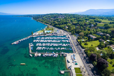 High angle view of city by sea against sky