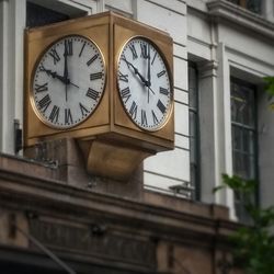 Low angle view of clock on wall