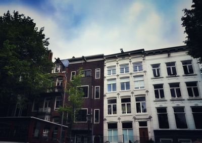 Low angle view of building against cloudy sky