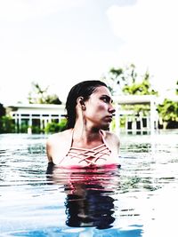 Young woman looking at swimming pool