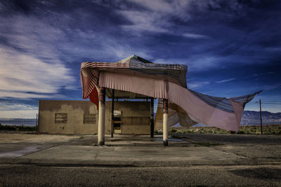 Built structure on road by building against sky