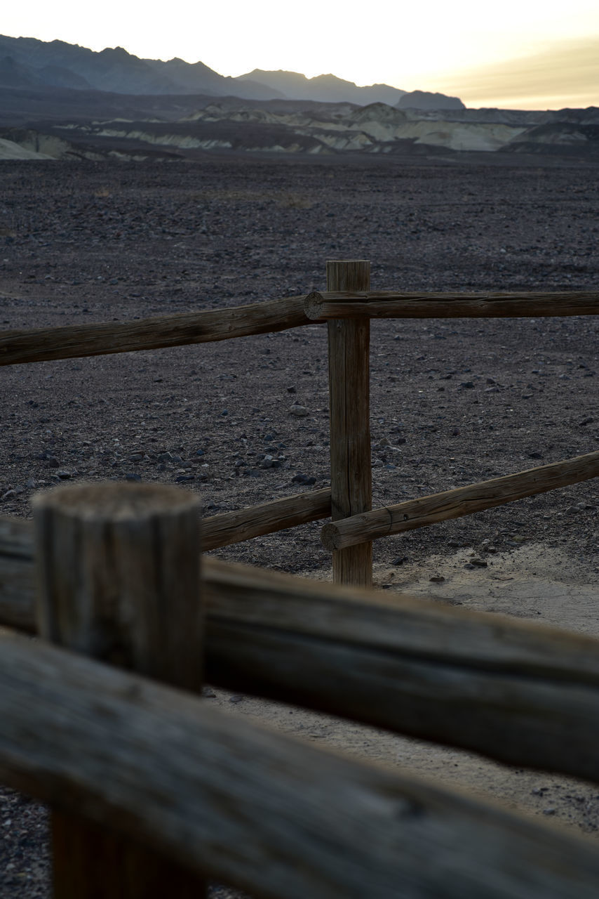 CLOSE-UP OF RAILING BY WATER