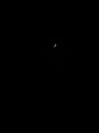 Low angle view of silhouette moon against sky at night