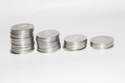 Close-up of coins on table against white background