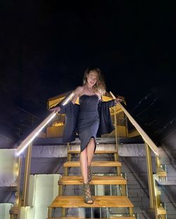 Full length of woman standing on staircase