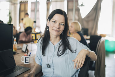 Portrait of a young woman using phone