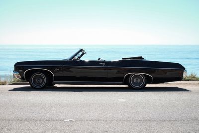 Close-up of car on beach against clear sky