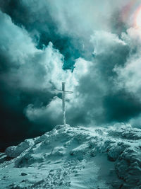 Low angle view of snow covered mountain against sky