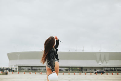 Rear view of woman walking on road