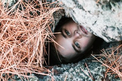 High angle portrait of young man amidst rocks