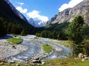 Scenic view of river against cloudy sky