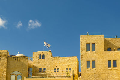 Low angle view of buildings against blue sky