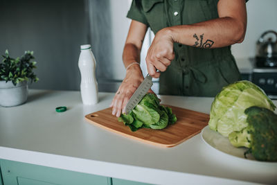 Midsection of man preparing food on table at home