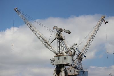 Low angle view of crane against sky