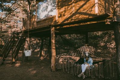 Full length of woman sitting in hammock