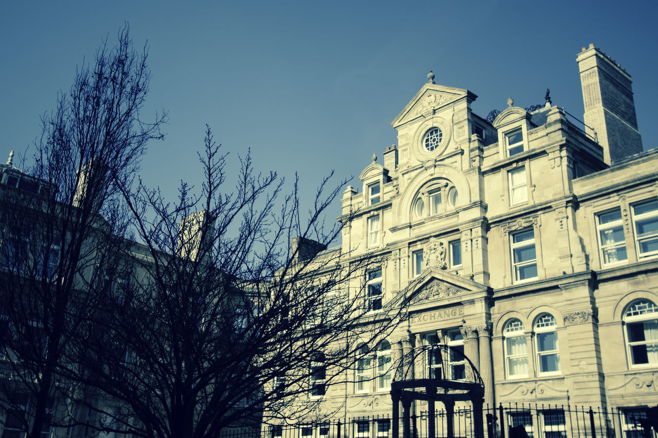 LOW ANGLE VIEW OF BUILDINGS AGAINST CLEAR SKY