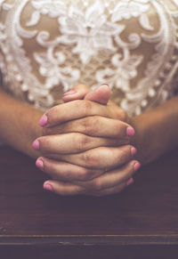 Midsection of woman praying