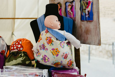 Doll and backpacks for sale at street market