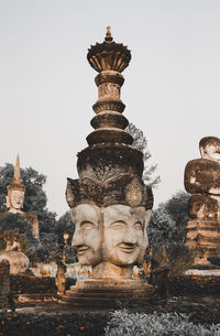 Statue of temple against building