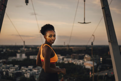 Portrait of woman standing against sky during sunset