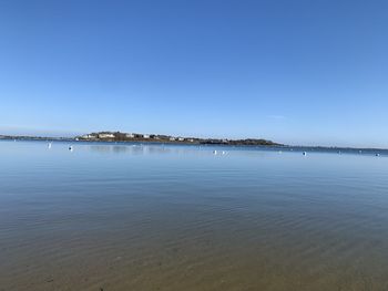 Scenic view of sea against clear blue sky