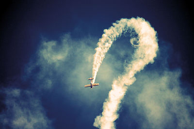 Low angle view of airplane flying against sky