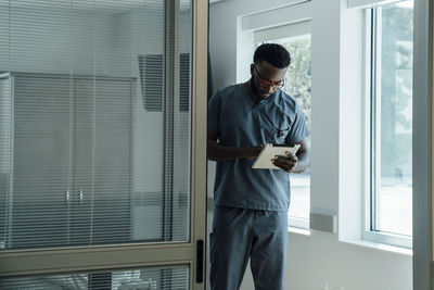 Doctor using tablet computer while working in hospital