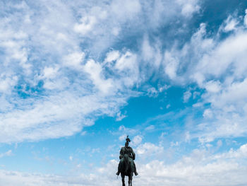 Low angle view of horse statue against sky