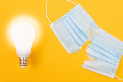 Close-up of illuminated light bulb on table
