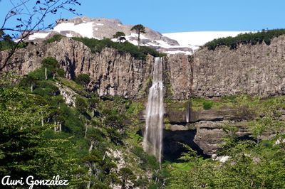 Scenic view of waterfall against sky