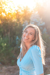 Portrait of smiling young woman standing outdoors