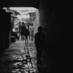 Full length of woman walking on illuminated street