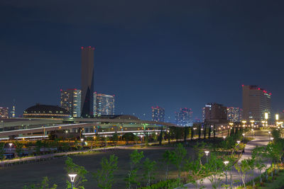 Illuminated buildings against sky at night