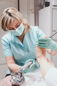 Chiropodist with patient at clinic