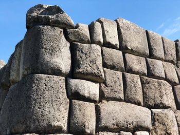 Low angle view of stone wall against sky