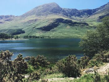 Scenic view of lake and mountains against sky