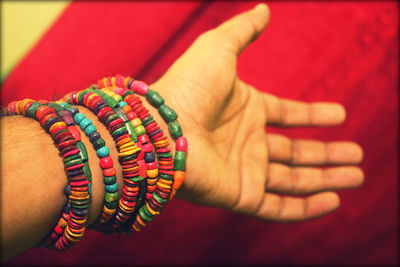 Close-up of hand wearing colorful bracelets