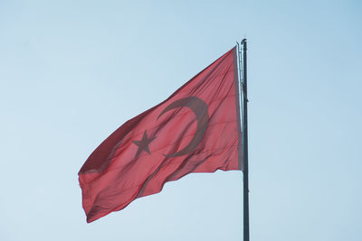 Low angle view of turkish flag against clear sky