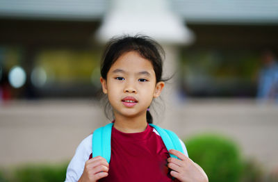 Portrait of cute girl carrying backpack