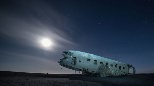 Abandoned airplane against sky