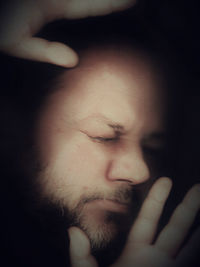 Close-up of mature man trapped behind glass