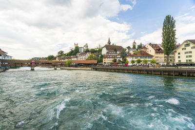 View of the city of luzern with the wooden bridge in summer