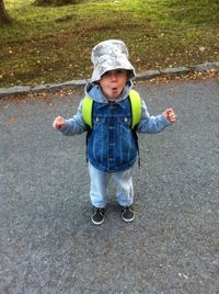 High angle portrait of cute boy standing on road