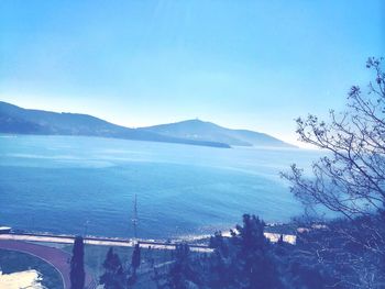 Scenic view of sea and mountains against sky