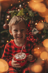 Portrait of boy playing christmas tree