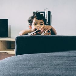 Portrait of man using mobile phone at home