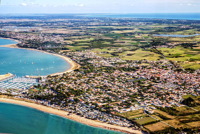 High angle view of buildings by sea against sky