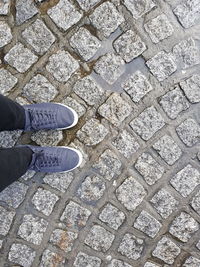 Low section of person standing on footpath