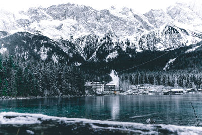 Scenic view of snowcapped mountains and lake during winter